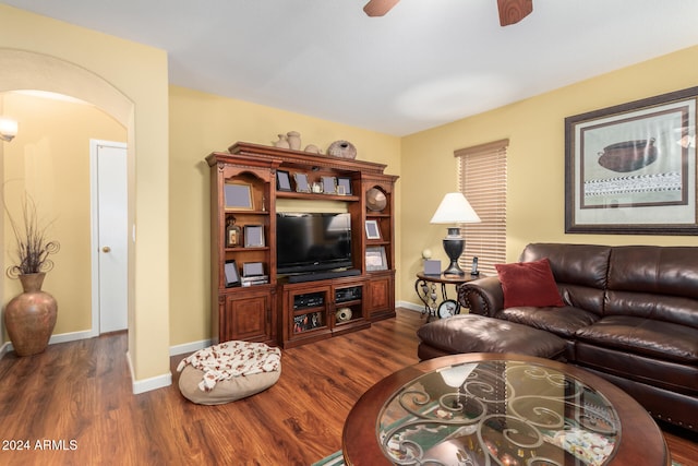 living room with ceiling fan and dark wood-type flooring