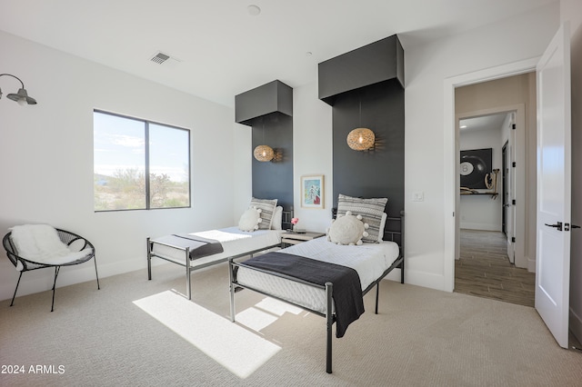 bedroom featuring light colored carpet