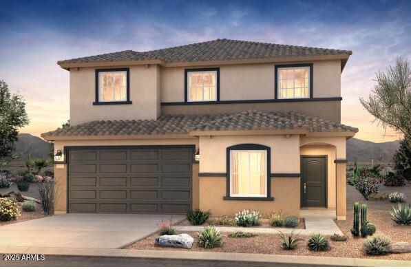 view of front of house with an attached garage, a tile roof, concrete driveway, and stucco siding