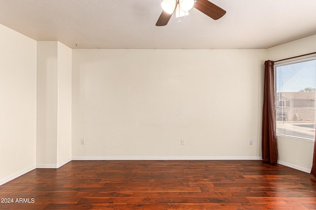 empty room featuring ceiling fan and dark hardwood / wood-style flooring