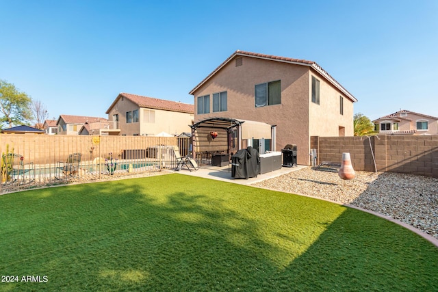 rear view of house featuring a pergola, a patio area, and a yard