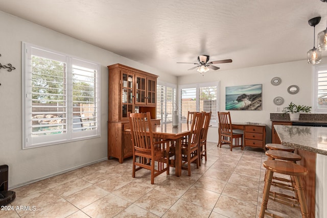 dining area with ceiling fan and light tile patterned flooring