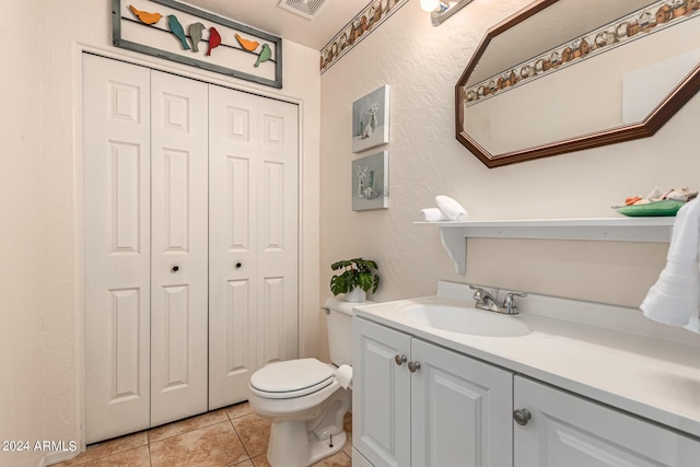 bathroom featuring toilet, tile patterned floors, and vanity