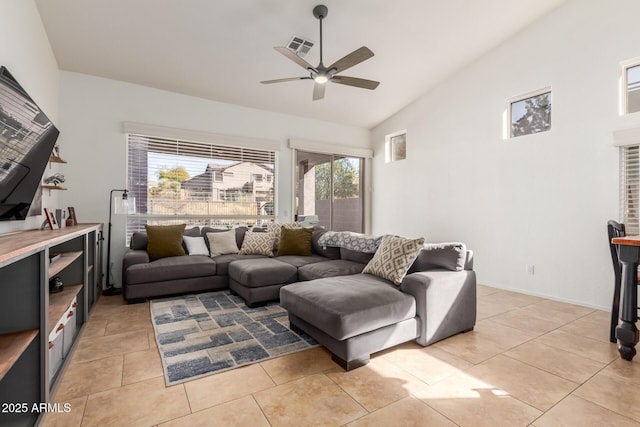 living room featuring ceiling fan, light tile patterned floors, and vaulted ceiling