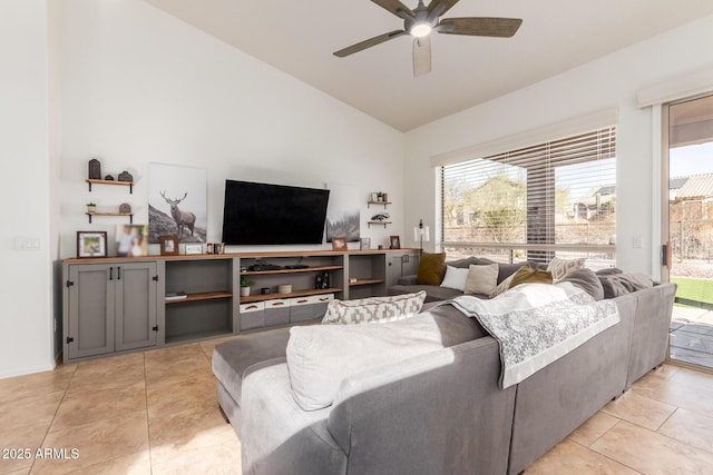 tiled living room featuring ceiling fan and high vaulted ceiling