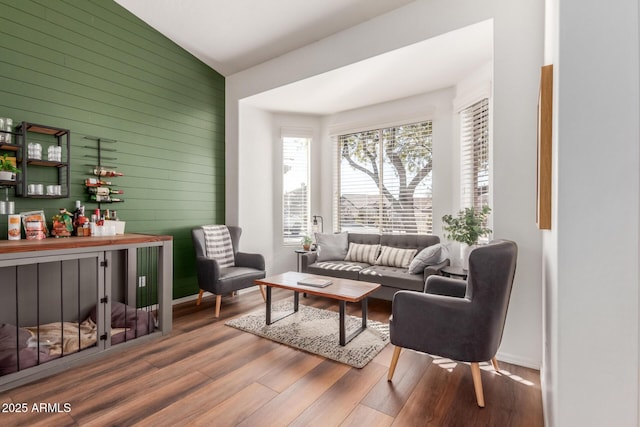 living room featuring hardwood / wood-style flooring and vaulted ceiling