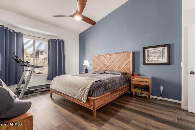 bedroom featuring ceiling fan, dark hardwood / wood-style flooring, and vaulted ceiling