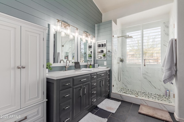 bathroom with lofted ceiling, tile patterned floors, vanity, walk in shower, and wood walls