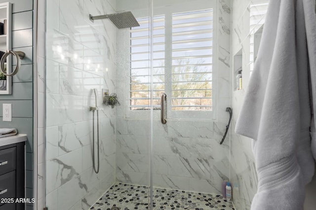 bathroom featuring walk in shower and vanity