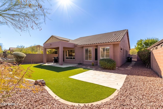 rear view of property featuring central air condition unit, a yard, and a patio