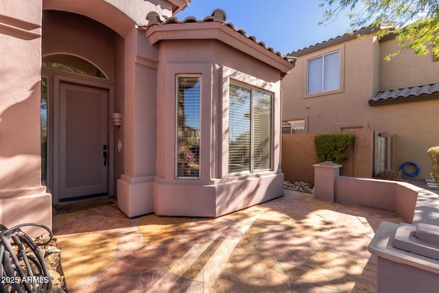 property entrance featuring a patio