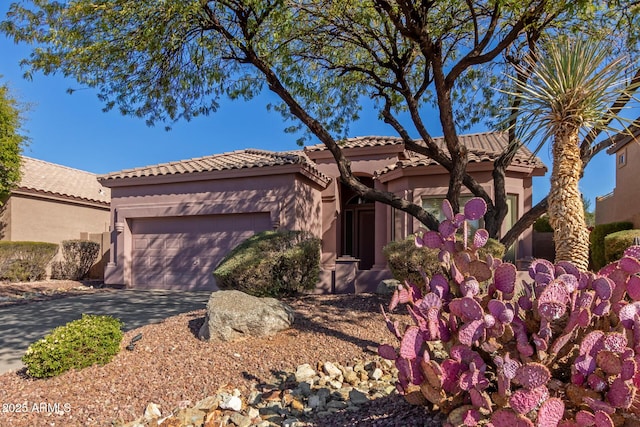 mediterranean / spanish-style home featuring a garage