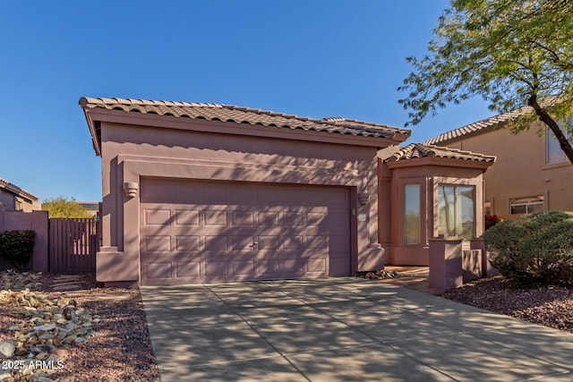 mediterranean / spanish-style home with a garage