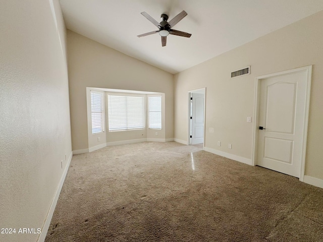 carpeted spare room featuring ceiling fan and high vaulted ceiling