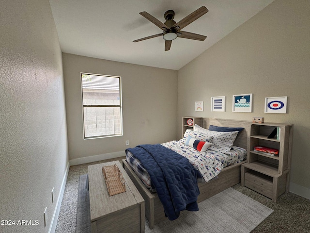 carpeted bedroom featuring ceiling fan and vaulted ceiling