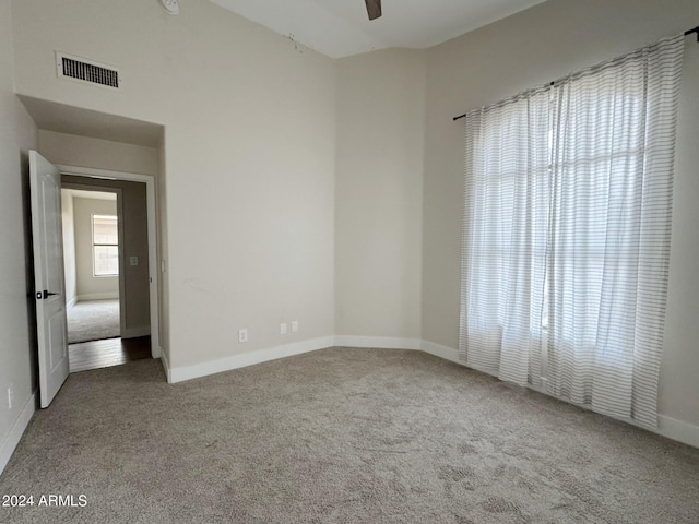 carpeted empty room with ceiling fan