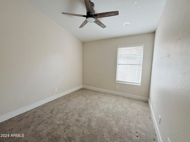 unfurnished room with ceiling fan and light colored carpet