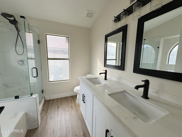 full bathroom with vanity, separate shower and tub, vaulted ceiling, hardwood / wood-style floors, and toilet