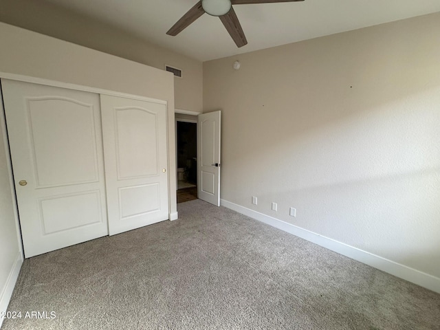 unfurnished bedroom featuring carpet flooring, ceiling fan, and a closet