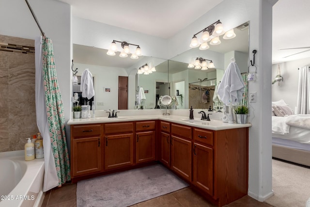 bathroom with connected bathroom, a sink, visible vents, tile patterned floors, and double vanity