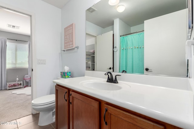 full bath with visible vents, vanity, toilet, and tile patterned floors