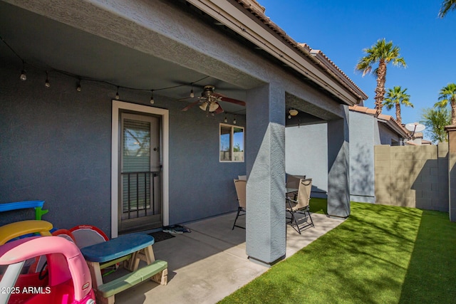 view of patio / terrace featuring fence and a ceiling fan