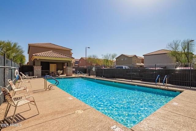 pool featuring a patio and fence