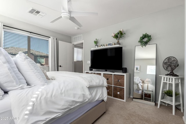 carpeted bedroom with ceiling fan and visible vents