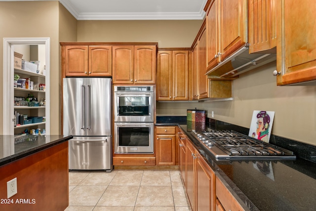 kitchen featuring ornamental molding, appliances with stainless steel finishes, light tile patterned flooring, and dark stone counters