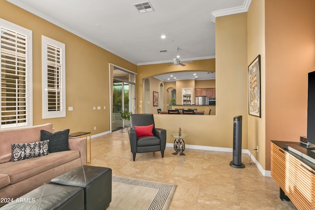 tiled living room featuring ceiling fan and ornamental molding