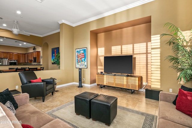 living room with light tile patterned floors, ornamental molding, and ceiling fan