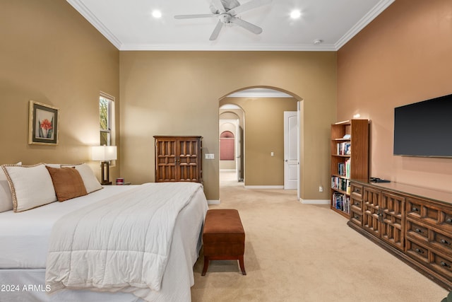 carpeted bedroom with ceiling fan, a towering ceiling, and ornamental molding