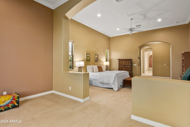 carpeted bedroom featuring crown molding and ceiling fan