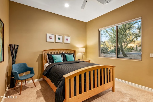 bedroom featuring ceiling fan and light carpet