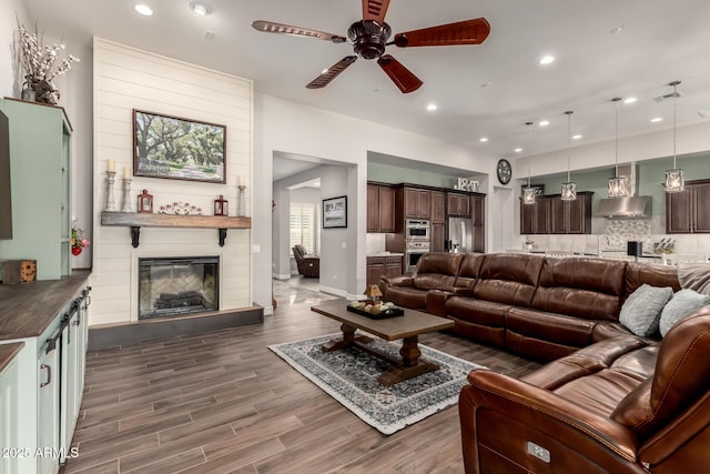 living room featuring wood finished floors, recessed lighting, and ceiling fan
