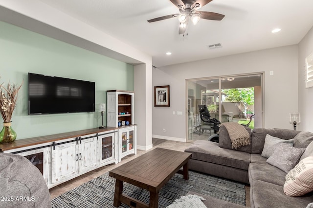living room featuring a ceiling fan, visible vents, and recessed lighting