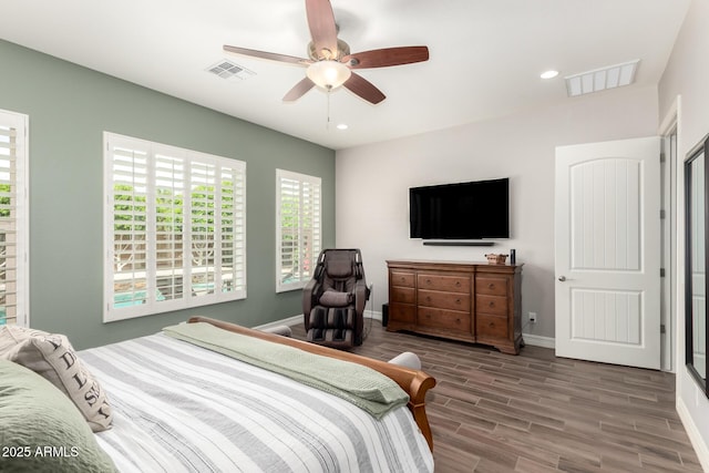 bedroom featuring baseboards, wood finished floors, visible vents, and recessed lighting
