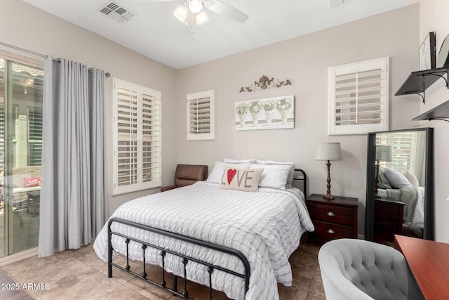 bedroom featuring a ceiling fan, visible vents, and light tile patterned floors