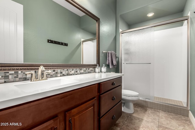 full bathroom with a sink, a shower stall, tasteful backsplash, and toilet