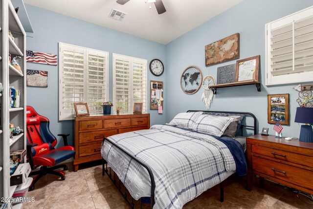 bedroom featuring visible vents, tile patterned floors, and ceiling fan