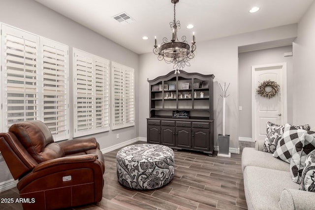 sitting room with baseboards, visible vents, recessed lighting, a notable chandelier, and wood finished floors