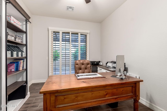 office area with visible vents, a ceiling fan, baseboards, and dark wood-style flooring