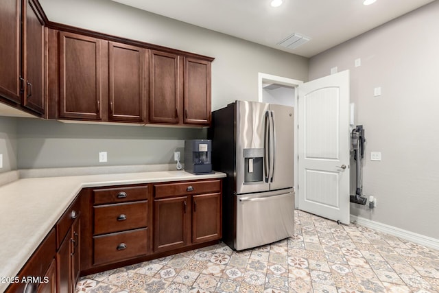 kitchen with visible vents, light countertops, baseboards, stainless steel refrigerator with ice dispenser, and recessed lighting