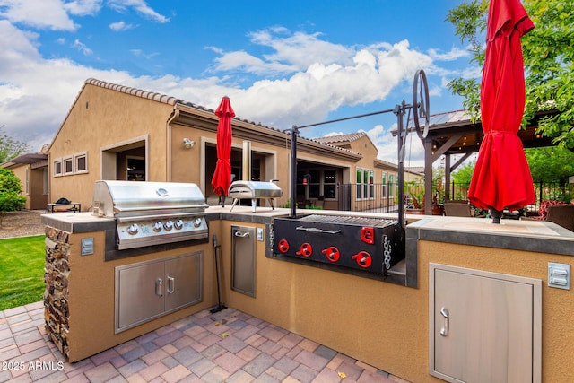 view of patio / terrace with an outdoor kitchen, area for grilling, and fence