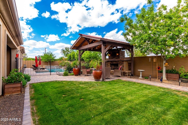 view of yard featuring an outdoor stone fireplace, a fenced in pool, a patio area, fence private yard, and a gazebo