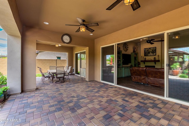 view of patio / terrace featuring fence, a ceiling fan, and outdoor dining area