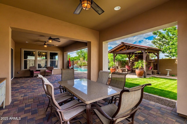 view of patio with ceiling fan, a fenced backyard, and outdoor dining space