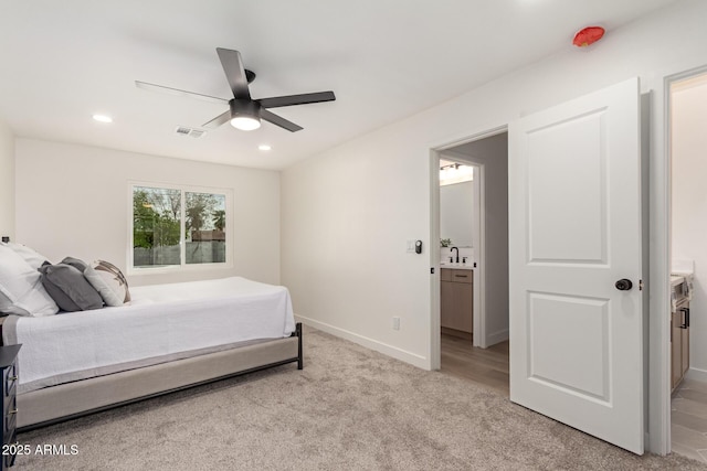 bedroom featuring a sink, recessed lighting, visible vents, and light carpet