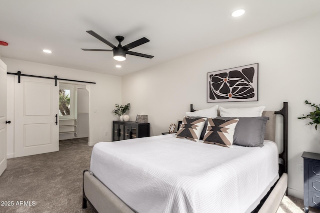 carpeted bedroom featuring recessed lighting, a barn door, and ceiling fan