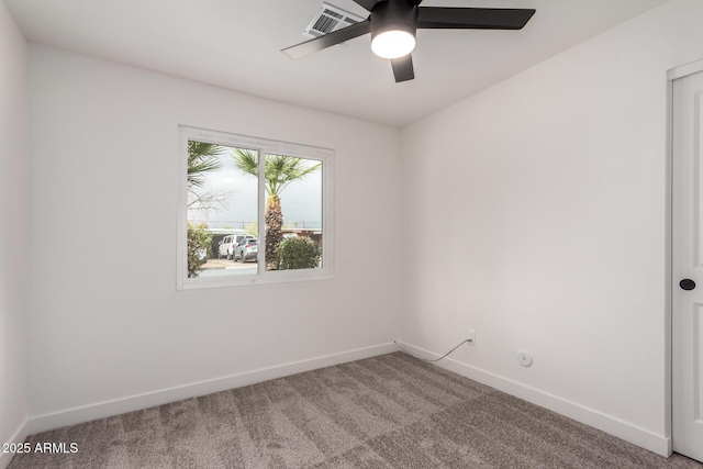 carpeted empty room with baseboards and a ceiling fan